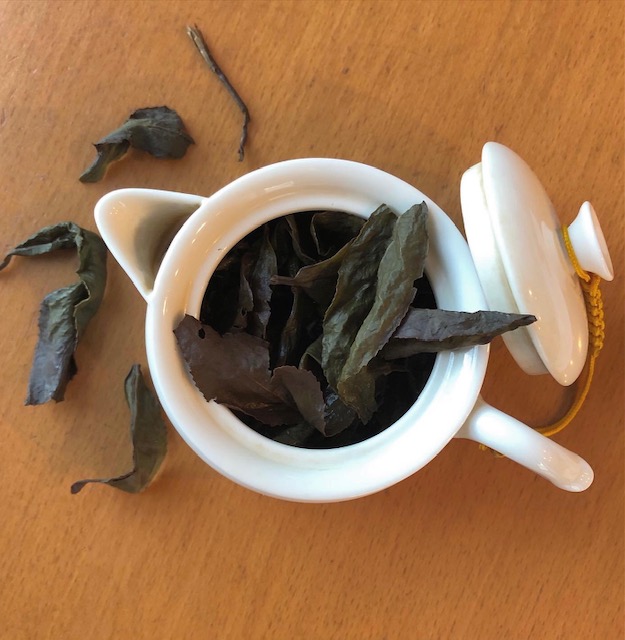 teapot with Tung Ting tea leaves spilling out