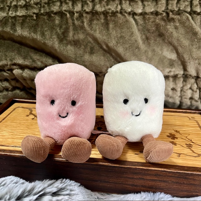 Pink and white smiling plushie marshmallows with little feet