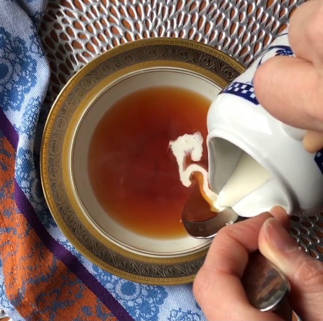 Pouring cream into East Frisian tea