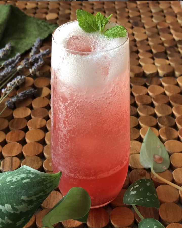 Valentine's tisane--tall glass of pink rose and ginger tisane with seltzer, garnished with a mint sprig