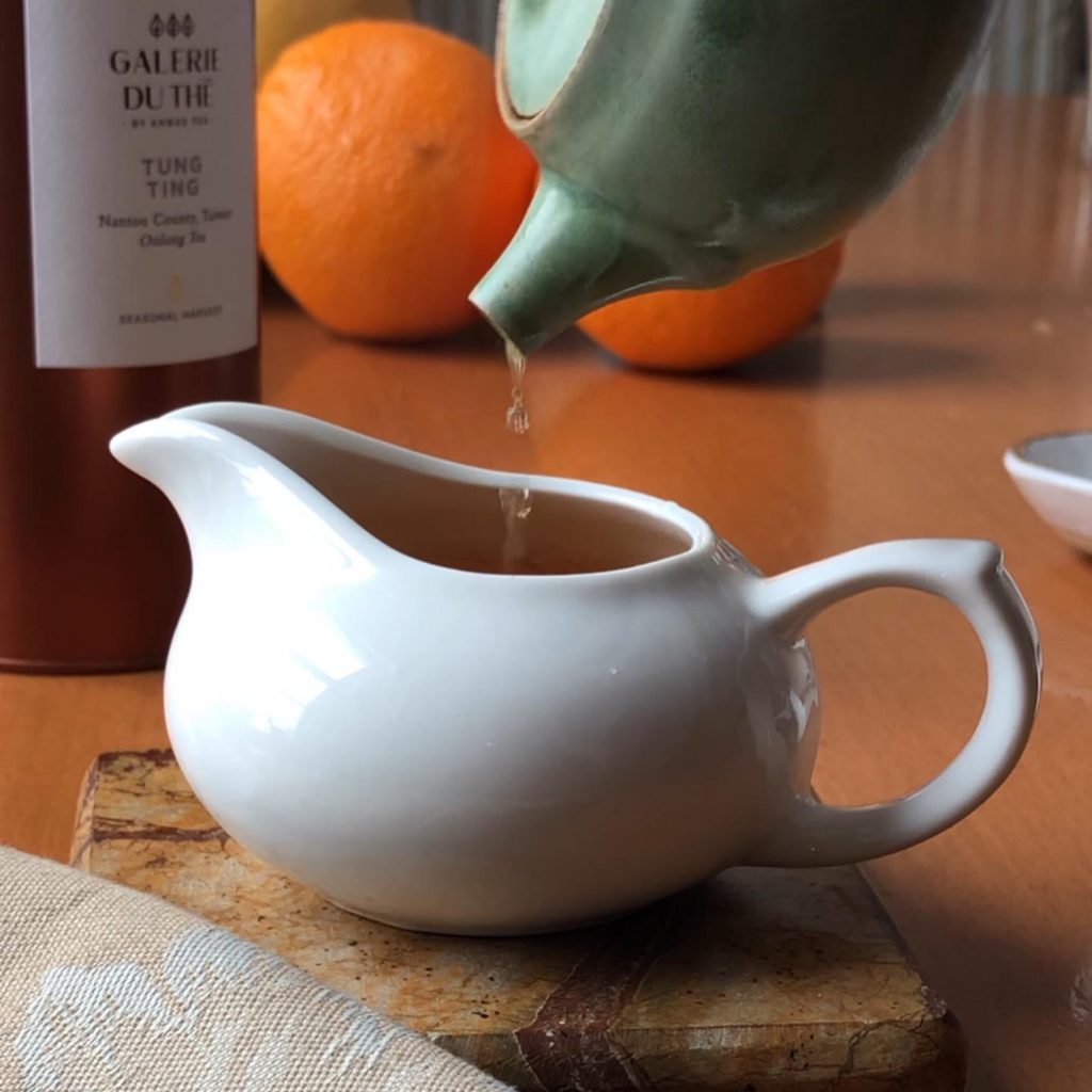 The last drops of Tung Ting tea transferred from teapot to fairness pitcher