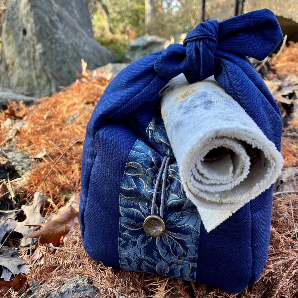 A tea accessory that taught me a lesson. Shown: Blue tea travel bag with flowered ribbon and button detail.