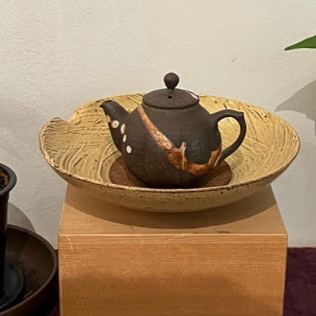 Beautiful clay teapot, dark chocolate brown with a coppery stripe and cream colored dots.
