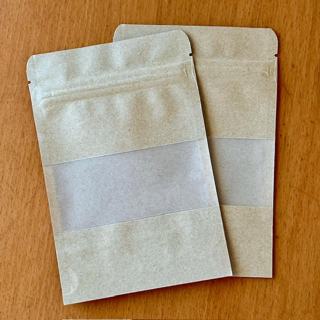 Two craft paper food storage bags with windows, useful to share and store small amounts of tea.