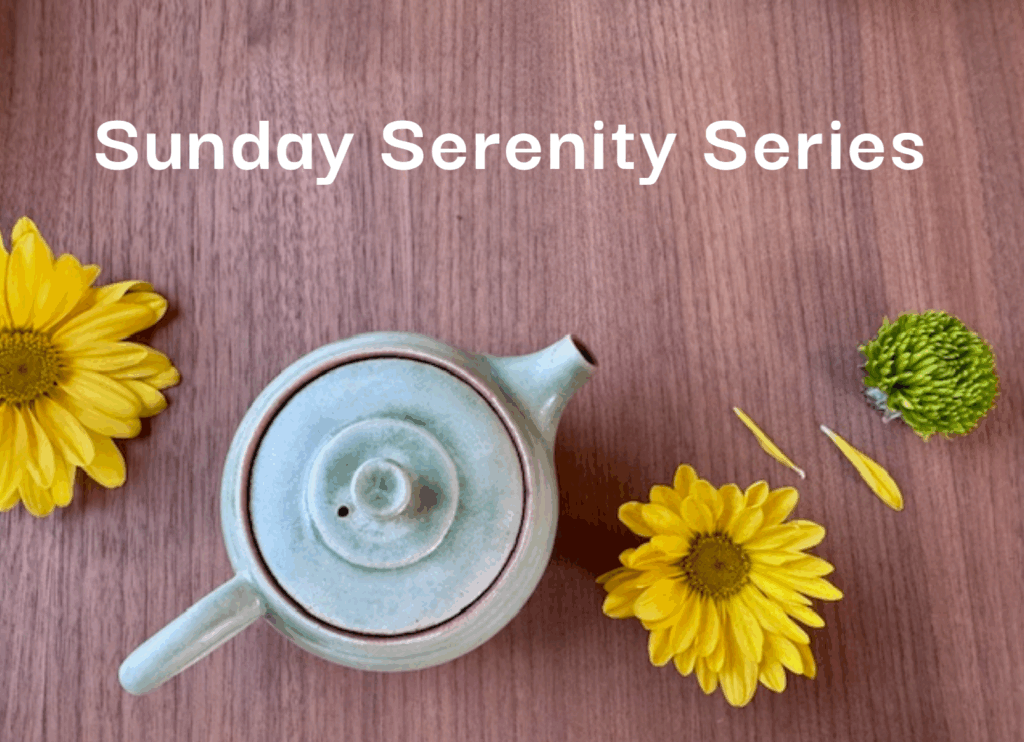 Green clay teapot, yellow flowers, and green flower on dark walnut board with words "Sunday Serenity Series."